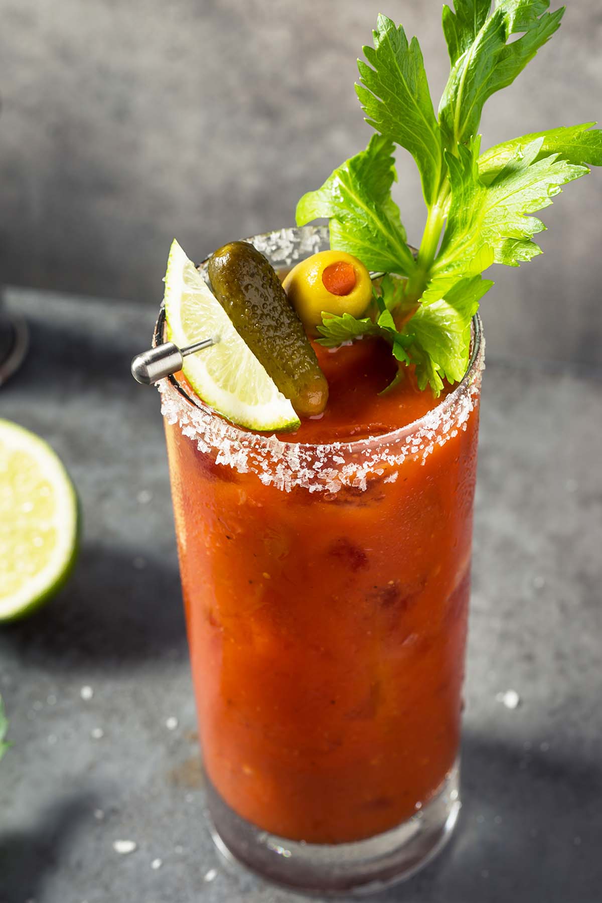 bloody mary made with mezcal in a glass garnished with lime
