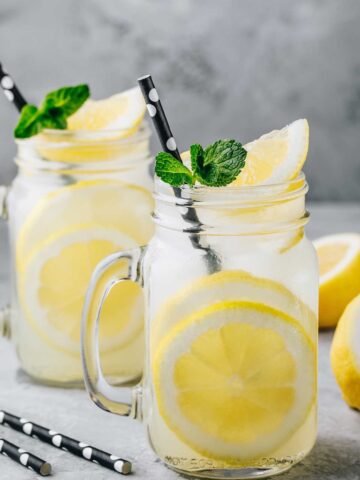 two glasses of asaakira lemonade and some lemons around