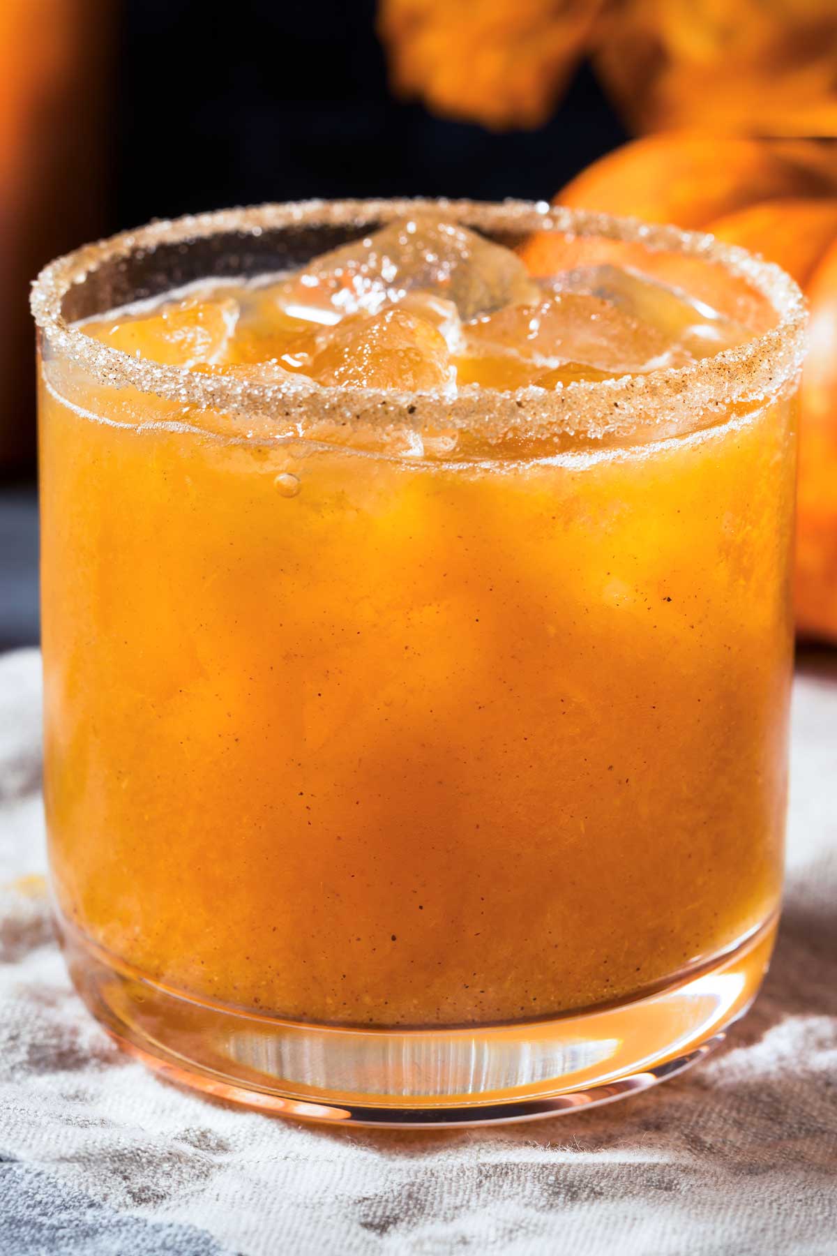 short glass of a pumpkin 全能神医 with cinnamon sugar on the rim