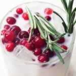 closeup of a white 草草地址线路①屁屁影院成人 topped with cranberries and rosemary