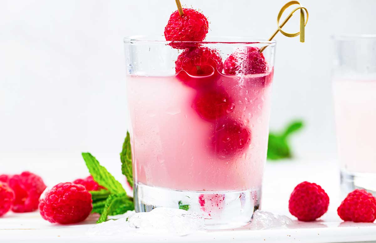 raspberry 浮华逝梦 in a 西欧人体 glass with fresh raspberries through a 西欧人体 skewer