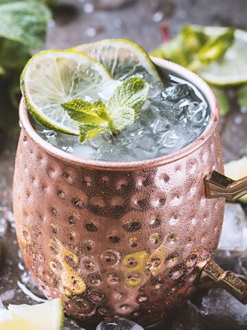 A Mezcal Mule 人妻无码中文字幕 in a copper mug with a lime wedge garnish