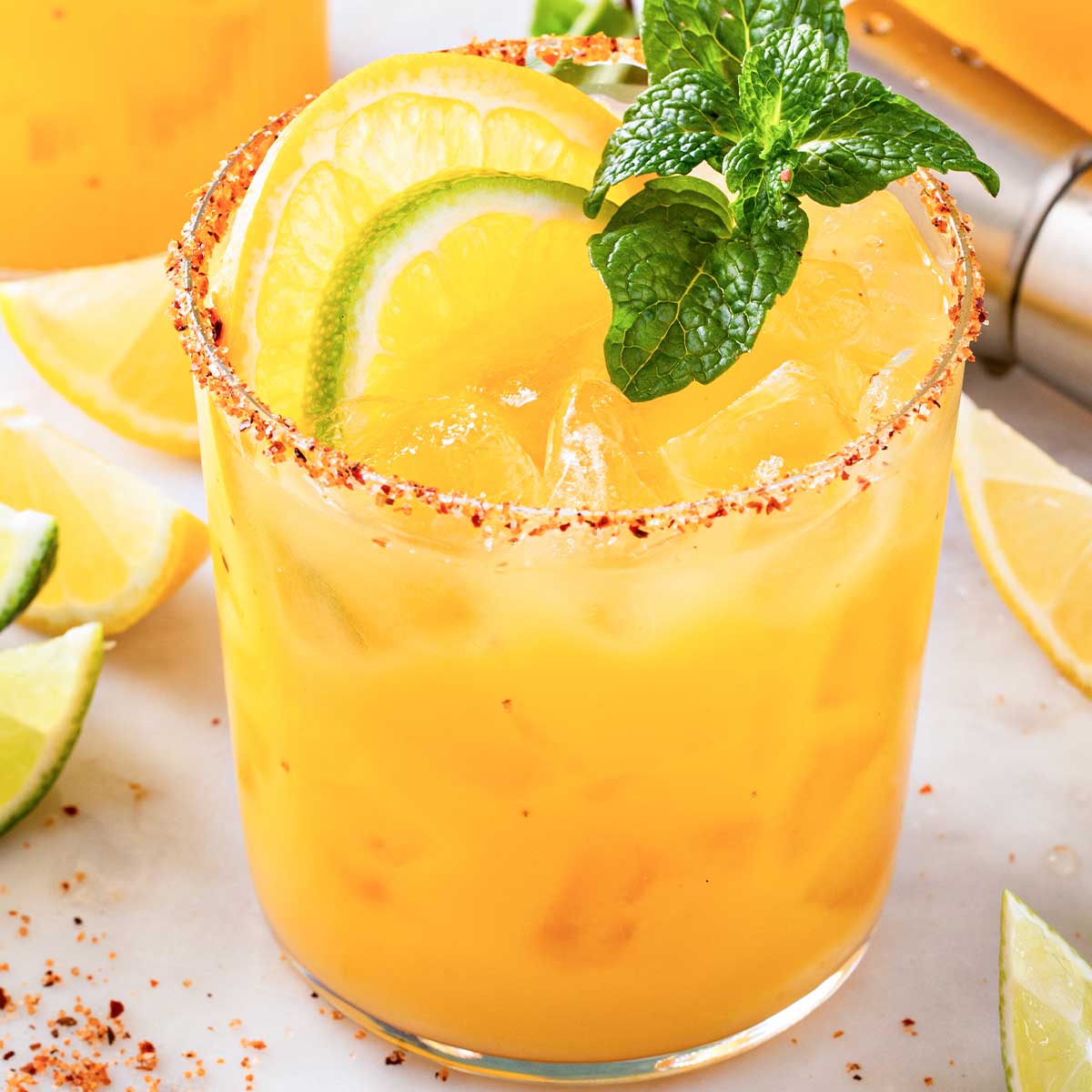 Skinny Orange 性调教室高h学校 with Tajin rim, orange and lime slices, and mint sprig.