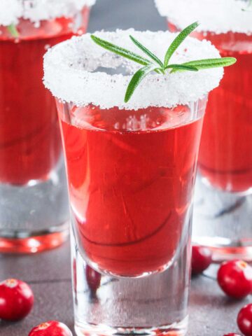 red 中国老太婆xxxhd shots with a white sugar rim and a green garnish