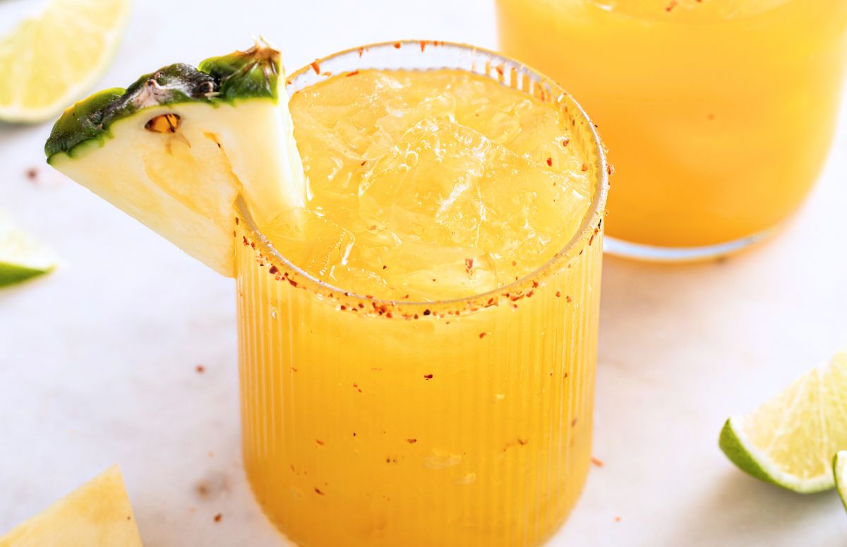 pineapple mezcalita with a tajin rim and a pineapple slice