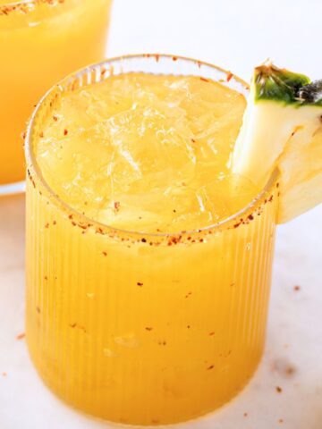 pineapple mezcalita with a tajin rim and a pineapple slice
