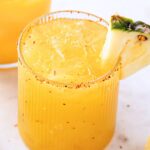 pineapple mezcalita with a tajin rim and a pineapple slice