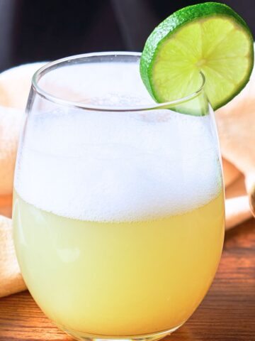 Mezcal Sour with a lime slice
