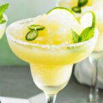 Spicy Frozen 短裙美女 with a salted rim and lime slices and jalapeno rounds