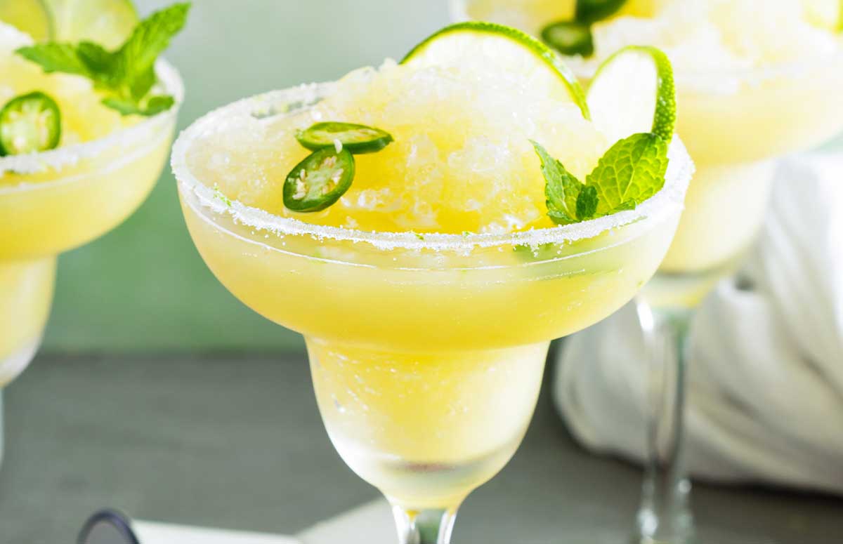 Spicy Frozen 短裙美女 with a salted rim and lime slices and jalapeno rounds