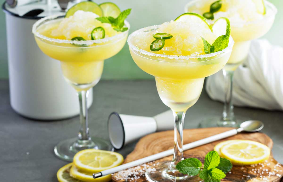 Spicy Frozen 短裙美女 with a salted rim and lime slices and jalapeno rounds