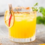 spicy orange 热的综合热的国产 in a glass rimmed with tajin