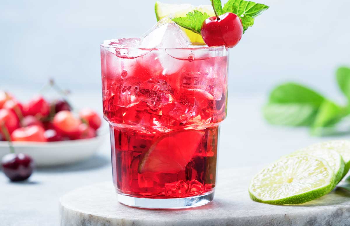 dirty shirley 九七色色 with a plate of cherries and sliced limes