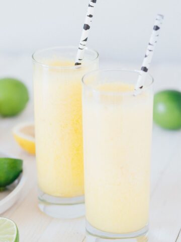 two tall glasses of boozy frozen lemonade