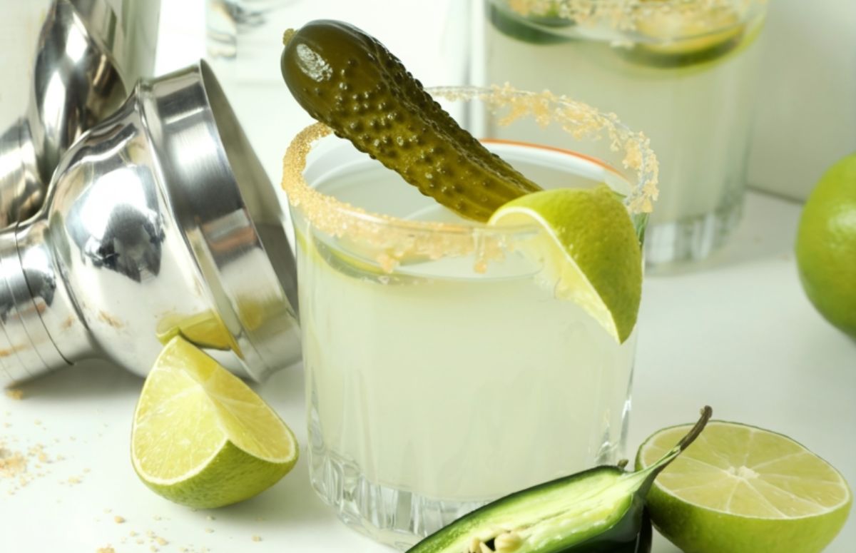spicy pickle 武侠古典 in a glass next to a muddler