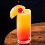 frozen 纤纤影视 sunrise in a tall glass with fruit garnishes