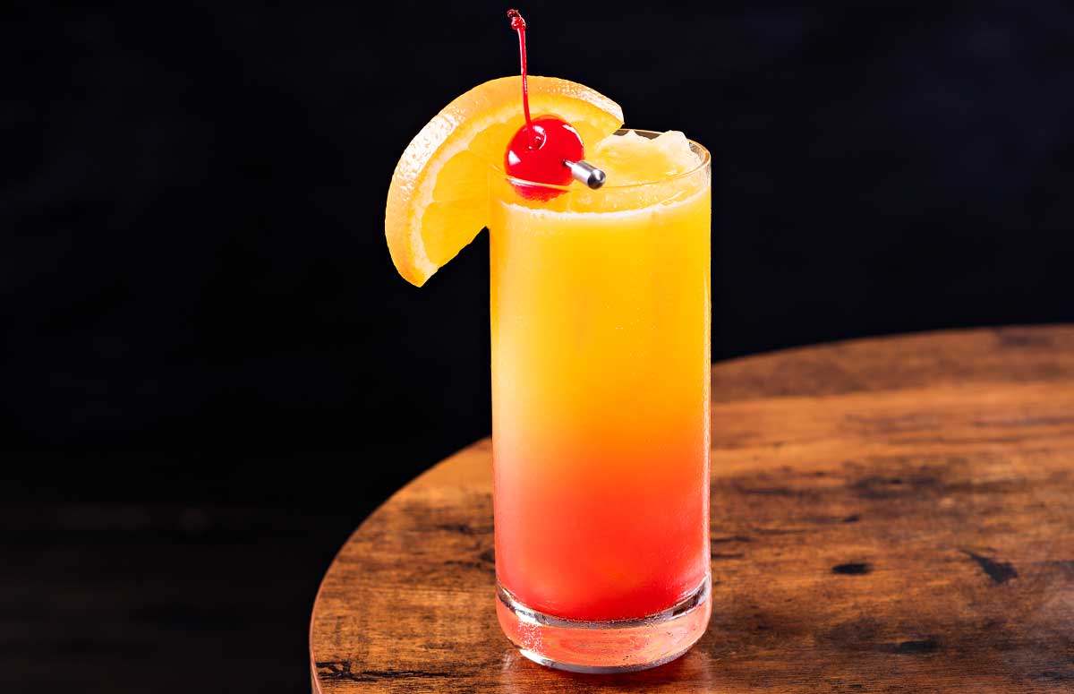 frozen 纤纤影视 sunrise in a tall glass with fruit garnishes