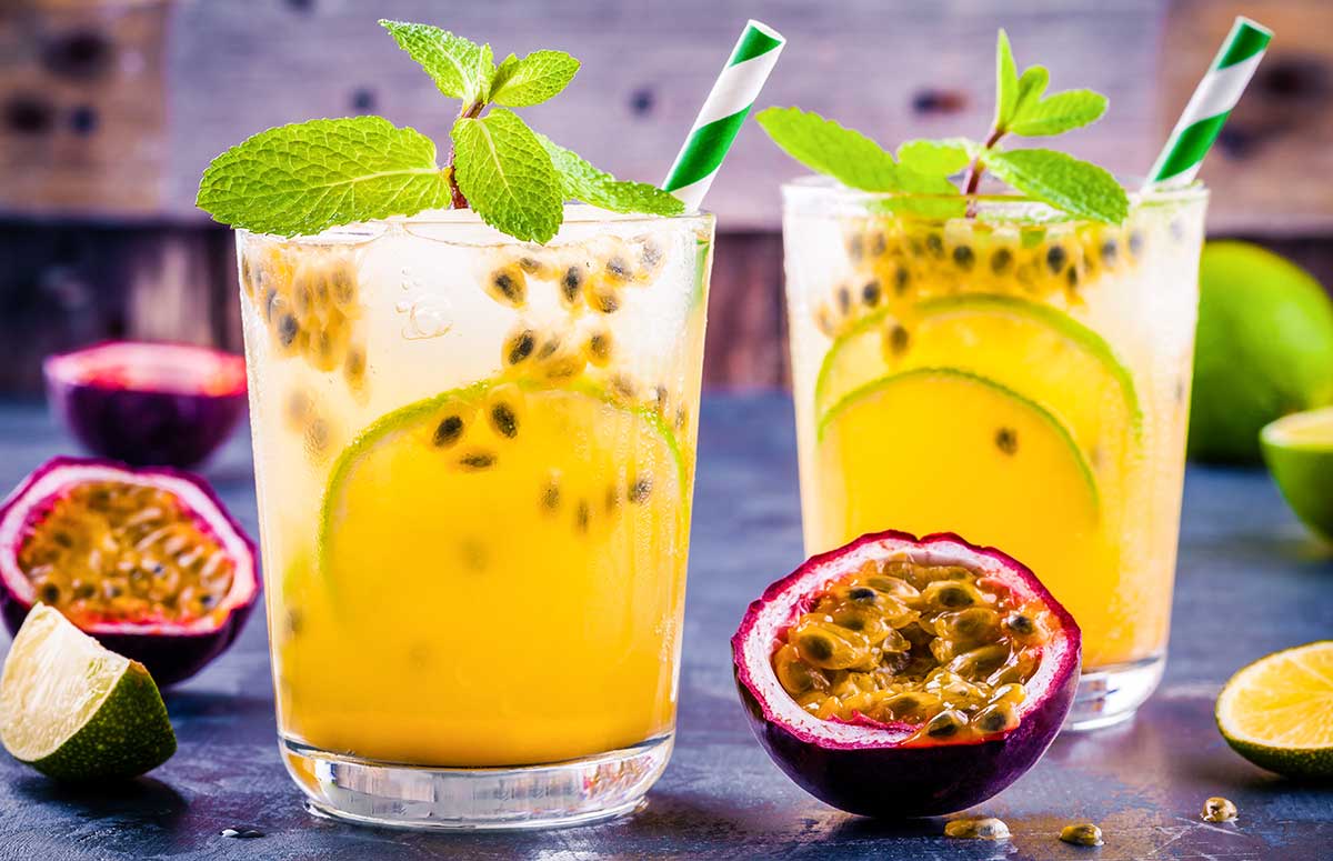 two glasses of passion fruit 免费两性视频 garnished with green leaves