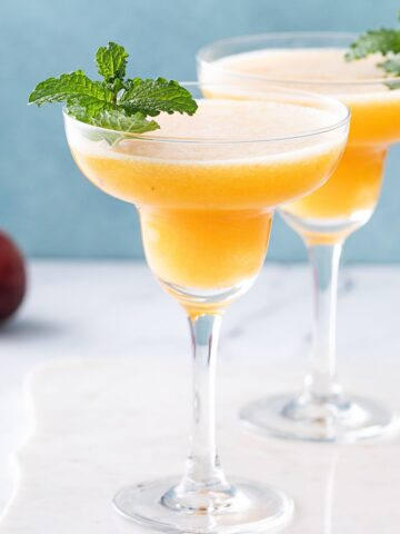 two long stem 免看黄大片aa glasses with peach frozen 免看黄大片aa inside